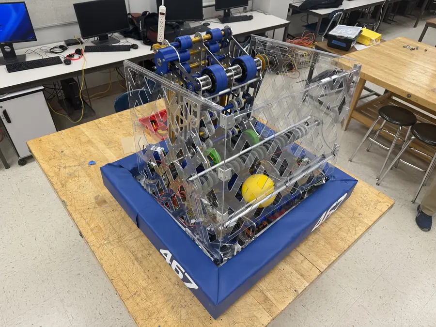 The assembled V1 robot on a workbench with a game piece inside